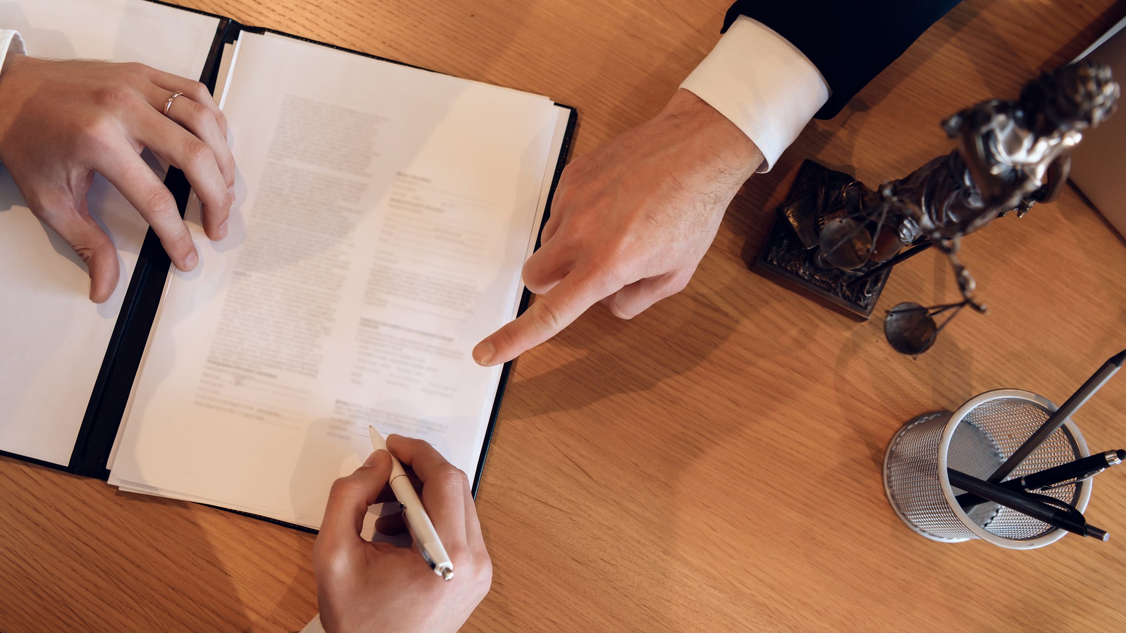 Man hand points with finger where to put signature